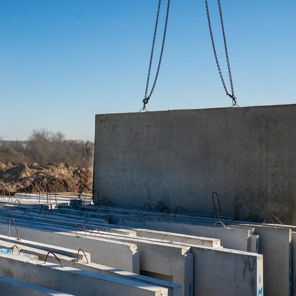 A freshly poured concrete wall is temporarily stored in wall storage for later placement
