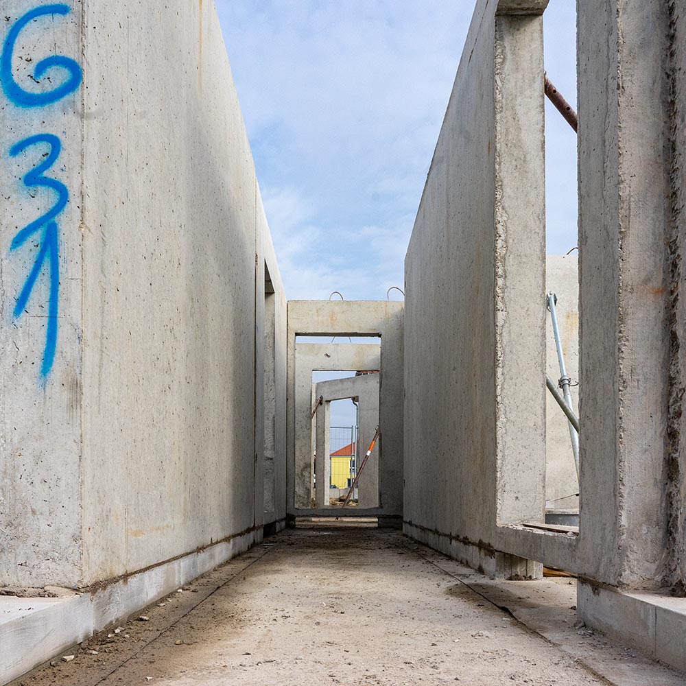 The first walls in the shell of an apartment building stand